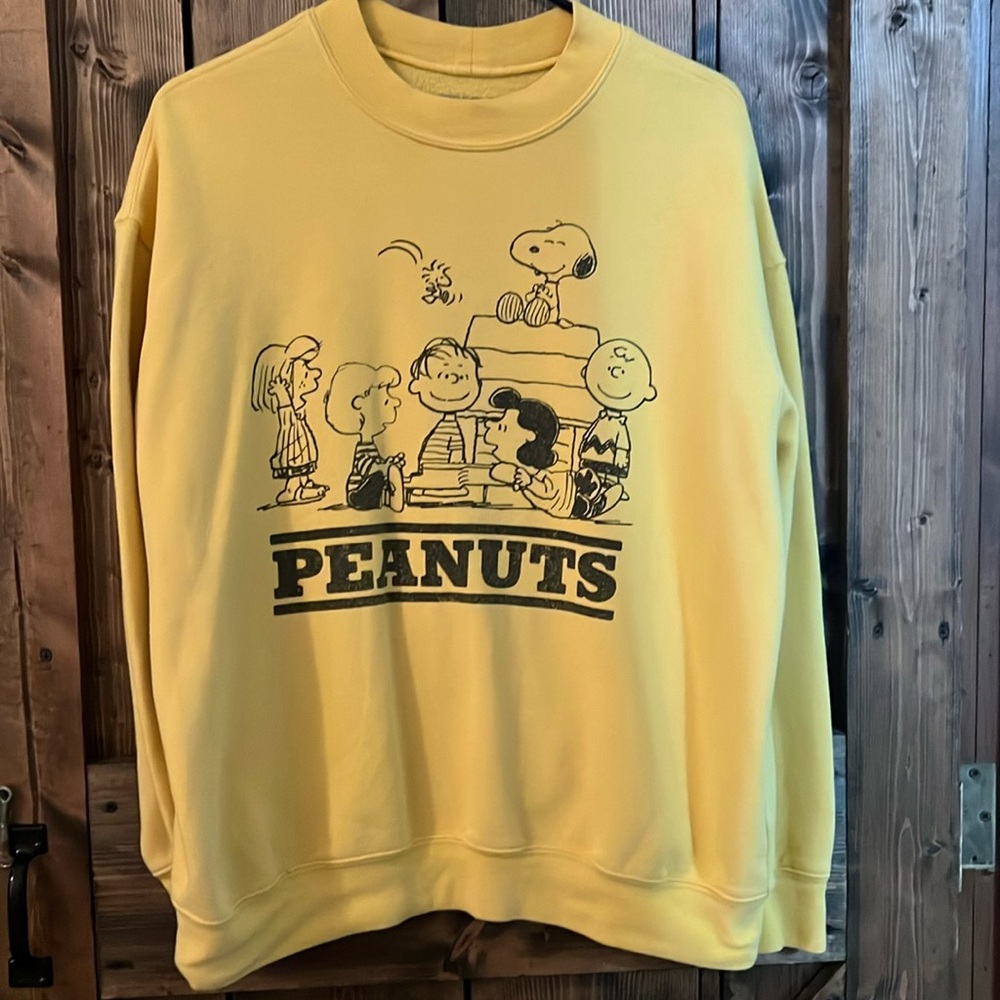 Peanuts size large pale yellow sweatshirt.